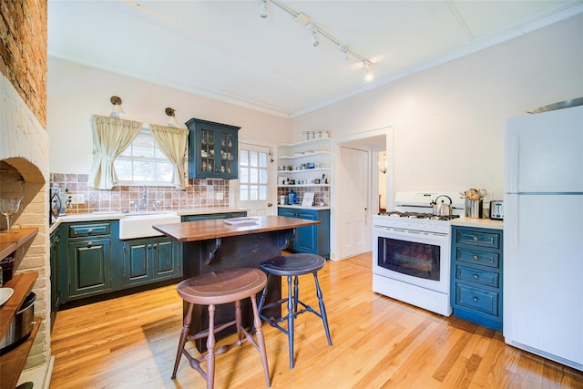 12 Beechwood Ter, Poughkeepsie, NY 12601 - kitchen with white appliances, rail lighting, wooden counters, a kitchen bar, and decorative backsplash