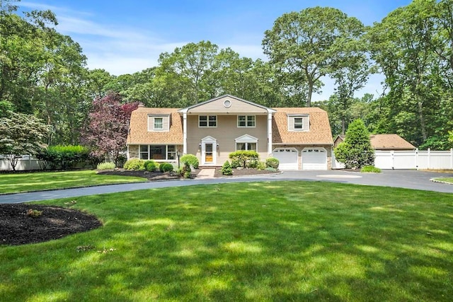15 Stillwood Rd, Brookhaven, NY 11719 - view of front of house featuring driveway, a gambrel roof, and view of wooded area
