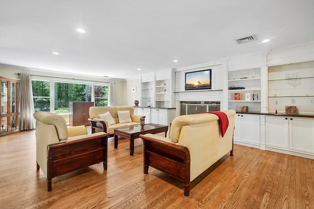 15 Stillwood Rd, Brookhaven, NY 11719 - living room featuring a fireplace, light wood-type flooring, recessed lighting, and ornamental molding