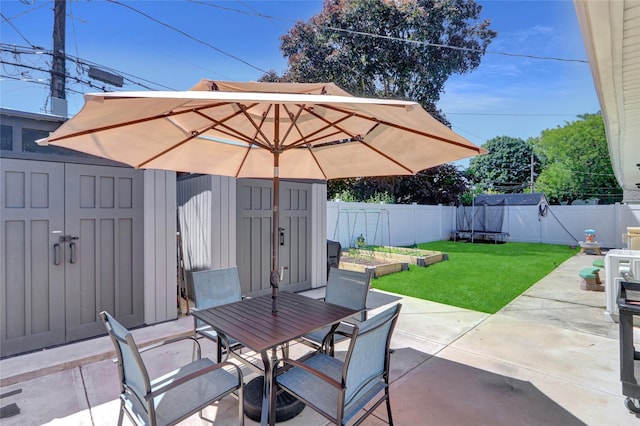 206 Friends Ln, Westbury, NY 11590 - fenced backyard with a shed, a patio area, outdoor dining space, and a garden