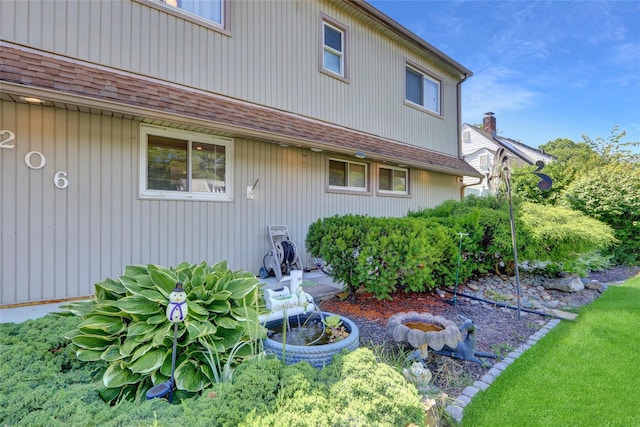 206 Friends Ln, Westbury, NY 11590 - back of property with a shingled roof