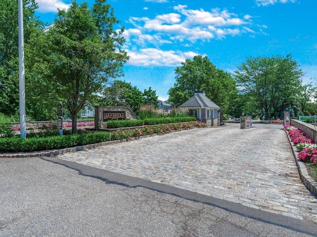 55 Lakebridge Dr S, Kings Park, NY 11754 - view of street featuring a gated entry and curbs