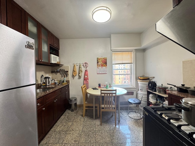 144-30 Sanford Ave Unit 4N, Flushing, NY 11355 - kitchen with freestanding refrigerator, black range with gas stovetop, granite tiled floors, white microwave, and glass insert cabinets
