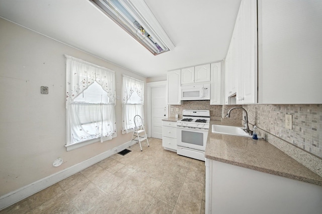20 Columbia Ave, Middletown, NY 10940 - kitchen with white appliances, white cabinetry, tasteful backsplash, and light stone countertops