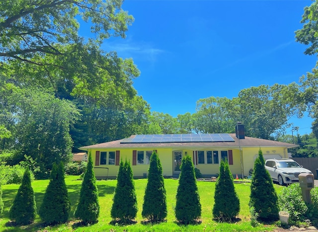190 Springdale Dr, Ronkonkoma, NY 11779 - ranch-style home with a front yard, a garage, and roof mounted solar panels