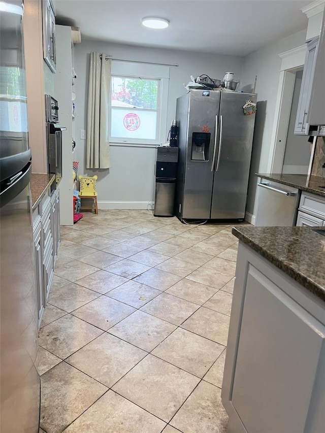 190 Springdale Dr, Ronkonkoma, NY 11779 - kitchen featuring stainless steel appliances, dark stone counters, and light tile patterned floors