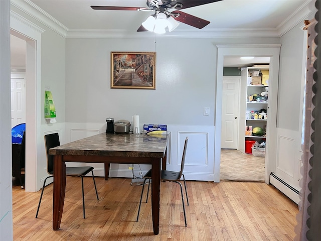 190 Springdale Dr, Ronkonkoma, NY 11779 - dining area with a baseboard radiator, ceiling fan, crown molding, light wood finished floors, and a wainscoted wall