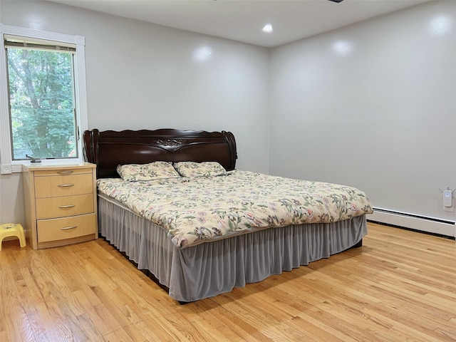 190 Springdale Dr, Ronkonkoma, NY 11779 - bedroom featuring a baseboard heating unit, light wood-type flooring, and recessed lighting