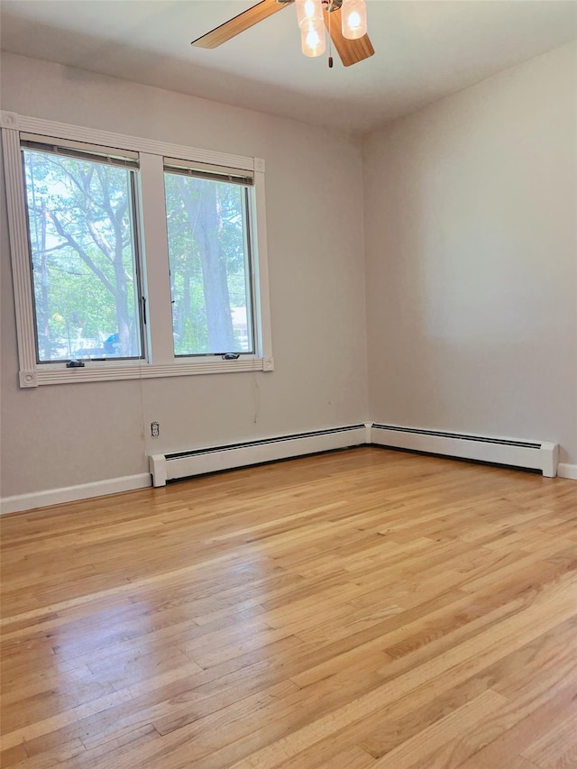190 Springdale Dr, Ronkonkoma, NY 11779 - unfurnished room with a baseboard radiator, light wood finished floors, and a ceiling fan