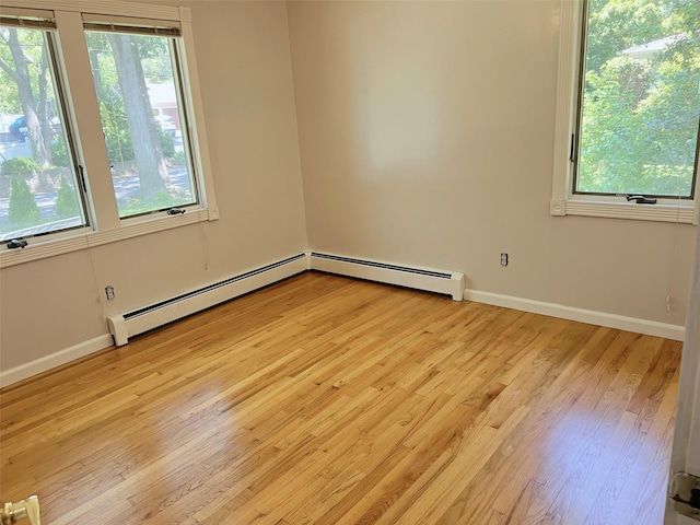 190 Springdale Dr, Ronkonkoma, NY 11779 - empty room featuring a baseboard radiator and light wood-style floors