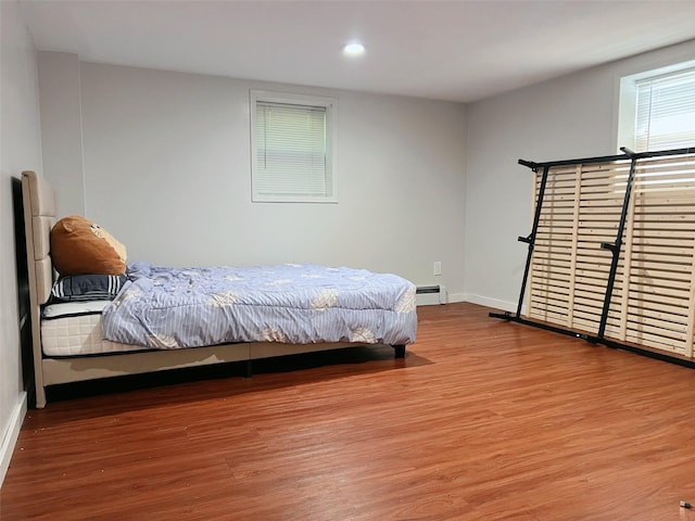 190 Springdale Dr, Ronkonkoma, NY 11779 - bedroom with a baseboard heating unit, wood finished floors, and recessed lighting
