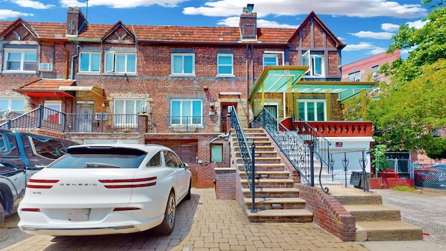 20 Corbin Pl, Brooklyn, NY 11235 - view of property with brick siding, a chimney, and stairway