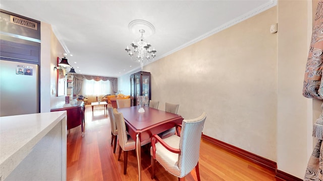 20 Corbin Pl, Brooklyn, NY 11235 - dining space featuring a chandelier, wood finished floors, and crown molding
