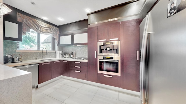 20 Corbin Pl, Brooklyn, NY 11235 - kitchen featuring appliances with stainless steel finishes, decorative backsplash, modern cabinets, light stone counters, and recessed lighting