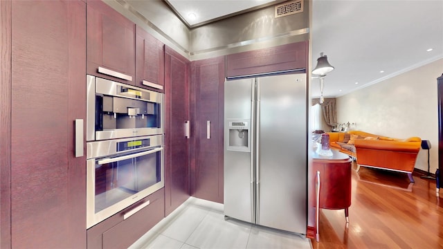 20 Corbin Pl, Brooklyn, NY 11235 - kitchen featuring appliances with stainless steel finishes, ornamental molding, reddish brown cabinets, and light tile patterned flooring