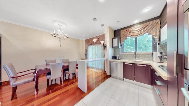 20 Corbin Pl, Brooklyn, NY 11235 - kitchen with stainless steel dishwasher, light countertops, a chandelier, ornamental molding, and backsplash