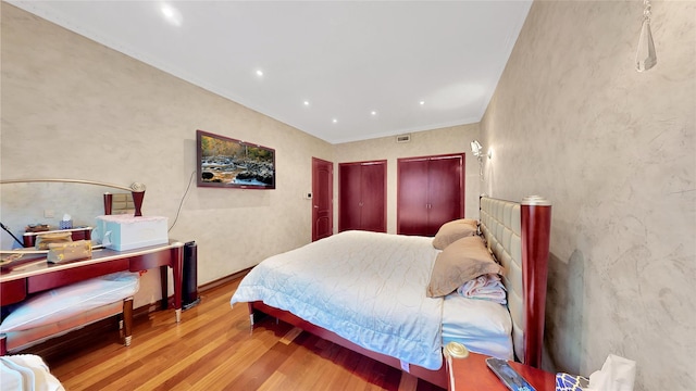 20 Corbin Pl, Brooklyn, NY 11235 - bedroom featuring wood finished floors, crown molding, and multiple closets