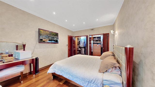 20 Corbin Pl, Brooklyn, NY 11235 - bedroom with light wood-type flooring, recessed lighting, crown molding, and a spacious closet