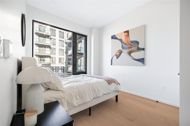 3116 21st St Unit Ph2F, Astoria, NY 11106 - bedroom featuring wood finished floors and baseboards