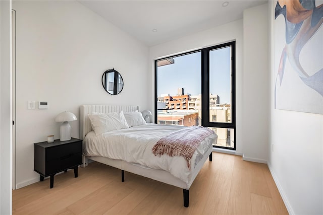3116 21st St Unit Ph2F, Astoria, NY 11106 - bedroom with light wood-type flooring and baseboards