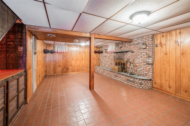 5 Hillaire Pl, Nanuet, NY 10954 - finished below grade area with wooden walls, a wood stove, and a paneled ceiling