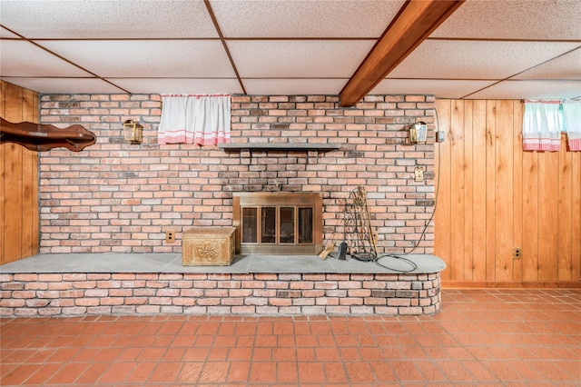 5 Hillaire Pl, Nanuet, NY 10954 - unfurnished living room featuring tile patterned floors, a fireplace, wooden walls, and a paneled ceiling