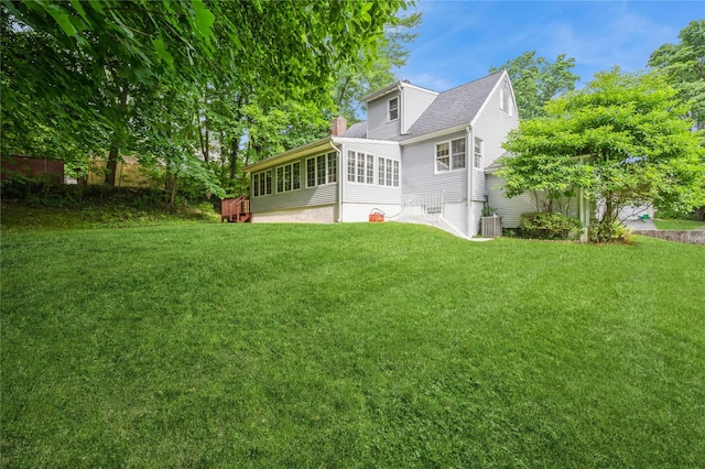 5 Hillaire Pl, Nanuet, NY 10954 - rear view of property with a sunroom, a chimney, a lawn, and a shingled roof
