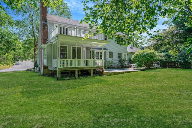 2 Seaview Ln, Mount Sinai, NY 11766 - back of property featuring a chimney, a balcony, and a wooden deck