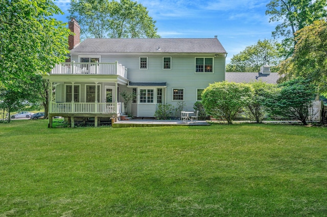 2 Seaview Ln, Mount Sinai, NY 11766 - rear view of house with a chimney, a yard, a wooden deck, and roof with shingles