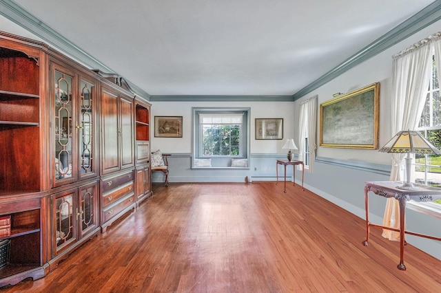 2 Seaview Ln, Mount Sinai, NY 11766 - unfurnished living room featuring a baseboard heating unit, wood finished floors, and crown molding