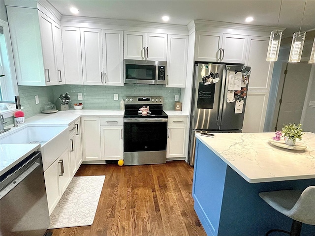 12 Russell Rd, Wappingers Falls, NY 12590 - kitchen with appliances with stainless steel finishes, dark wood-style flooring, decorative backsplash, white cabinets, and recessed lighting