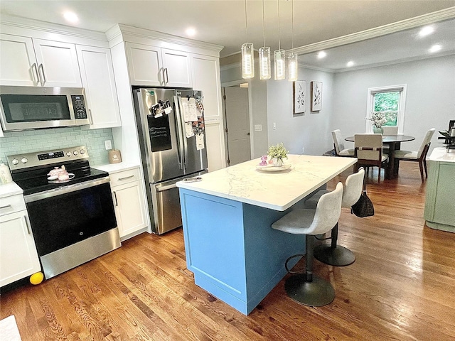 12 Russell Rd, Wappingers Falls, NY 12590 - kitchen with stainless steel appliances, ornamental molding, white cabinetry, a center island, and tasteful backsplash