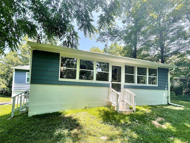 12 Russell Rd, Wappingers Falls, NY 12590 - view of front of property with concrete block siding, a front lawn, and entry steps