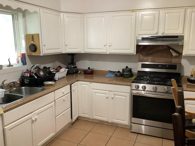 61 White St, Spring Valley, NY 10977 - kitchen featuring stainless steel range with gas stovetop, under cabinet range hood, white cabinets, and light tile patterned flooring