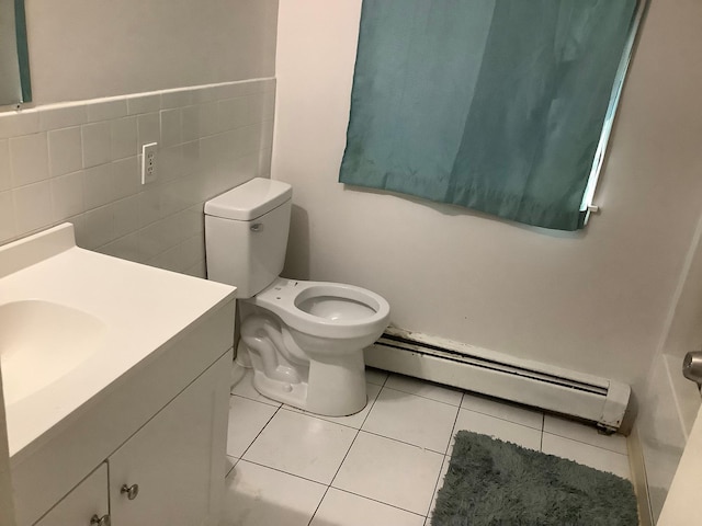 61 White St, Spring Valley, NY 10977 - bathroom with baseboard heating, vanity, tile patterned flooring, and tile walls