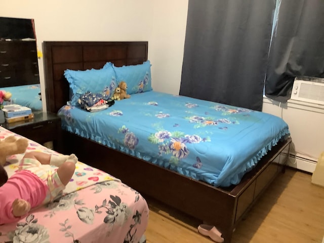 61 White St, Spring Valley, NY 10977 - bedroom with wood finished floors and a baseboard radiator