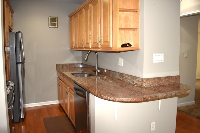 596 Broadway Unit 10B, Lynbrook, NY 11563 - kitchen with stainless steel appliances, dark wood-style floors, stone countertops, and a peninsula