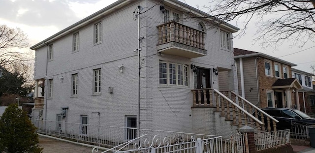 13035 126th S, Ozone Park, NY 11420 - view of side of home with a balcony and brick siding