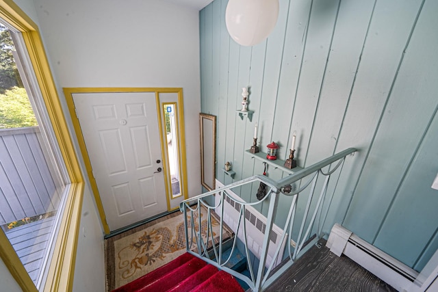 26 Liber Blvd, Farmingville, NY 11738 - foyer entrance with a baseboard radiator, wooden walls, and stairway