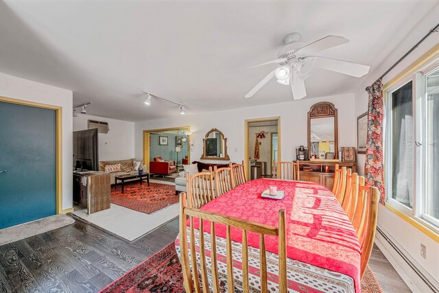 26 Liber Blvd, Farmingville, NY 11738 - dining room featuring a baseboard heating unit, wood finished floors, rail lighting, and ceiling fan