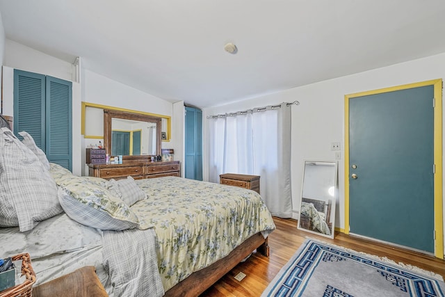 26 Liber Blvd, Farmingville, NY 11738 - bedroom featuring lofted ceiling, wood finished floors, and a closet