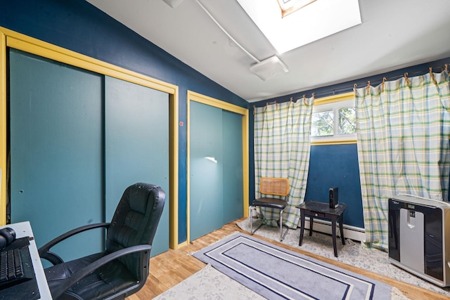 26 Liber Blvd, Farmingville, NY 11738 - office space featuring lofted ceiling, a baseboard heating unit, wood finished floors, and a skylight