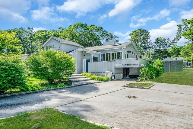 26 Liber Blvd, Farmingville, NY 11738 - mid-century modern home with concrete driveway and a carport