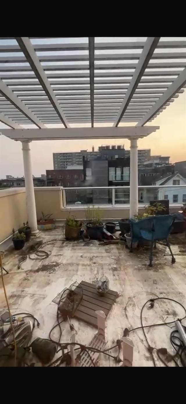180 Bch 101st St Unit 3C, Rockaway Beach, NY 11694 - patio terrace at dusk with a pergola and a patio
