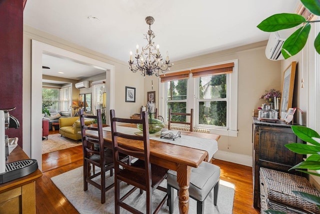 19 Russell St, Roslyn Heights, NY 11577 - dining room featuring a chandelier, wood finished floors, and a wall mounted AC