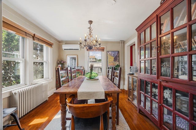 19 Russell St, Roslyn Heights, NY 11577 - dining room with radiator heating unit, a wall unit AC, a chandelier, dark wood-style flooring, and ornamental molding