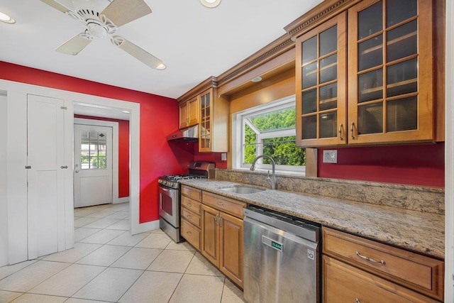19 Russell St, Roslyn Heights, NY 11577 - kitchen with stainless steel appliances, light tile patterned floors, brown cabinets, under cabinet range hood, and a ceiling fan