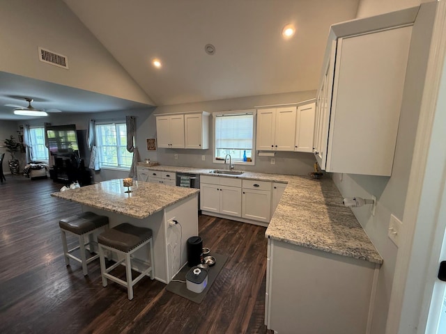 153 Ridgewood Ave, Middletown, NY 10940 - kitchen featuring a kitchen island, white cabinetry, dark wood-style flooring, a breakfast bar area, and recessed lighting