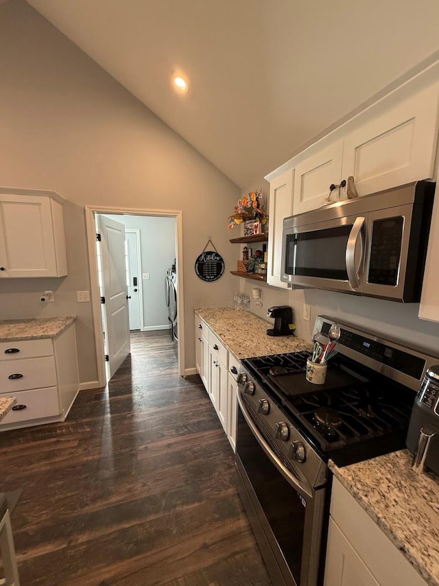 153 Ridgewood Ave, Middletown, NY 10940 - kitchen with stainless steel appliances, washer and clothes dryer, white cabinetry, light stone counters, and dark wood-style flooring