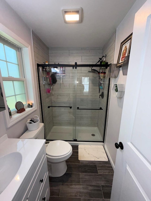 153 Ridgewood Ave, Middletown, NY 10940 - full bathroom featuring vanity, a shower stall, and wood tiled floors